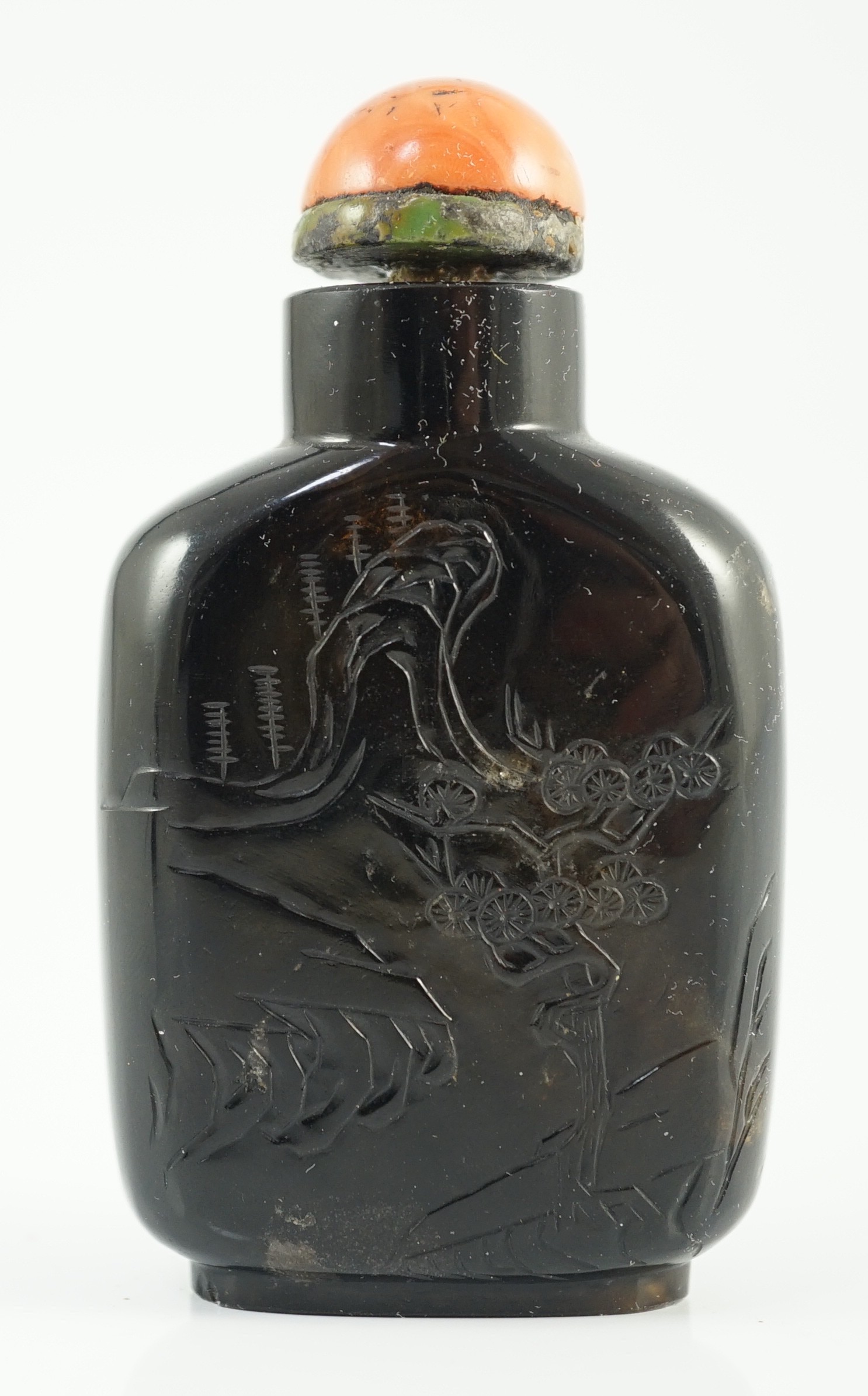 A Chinese smoky quartz snuff bottle, 1780-1820, 6.7cm high, coral stopper